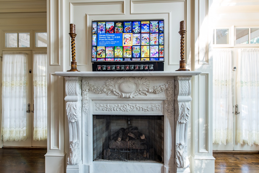 Luxury residential smart home with TV above marble fireplace