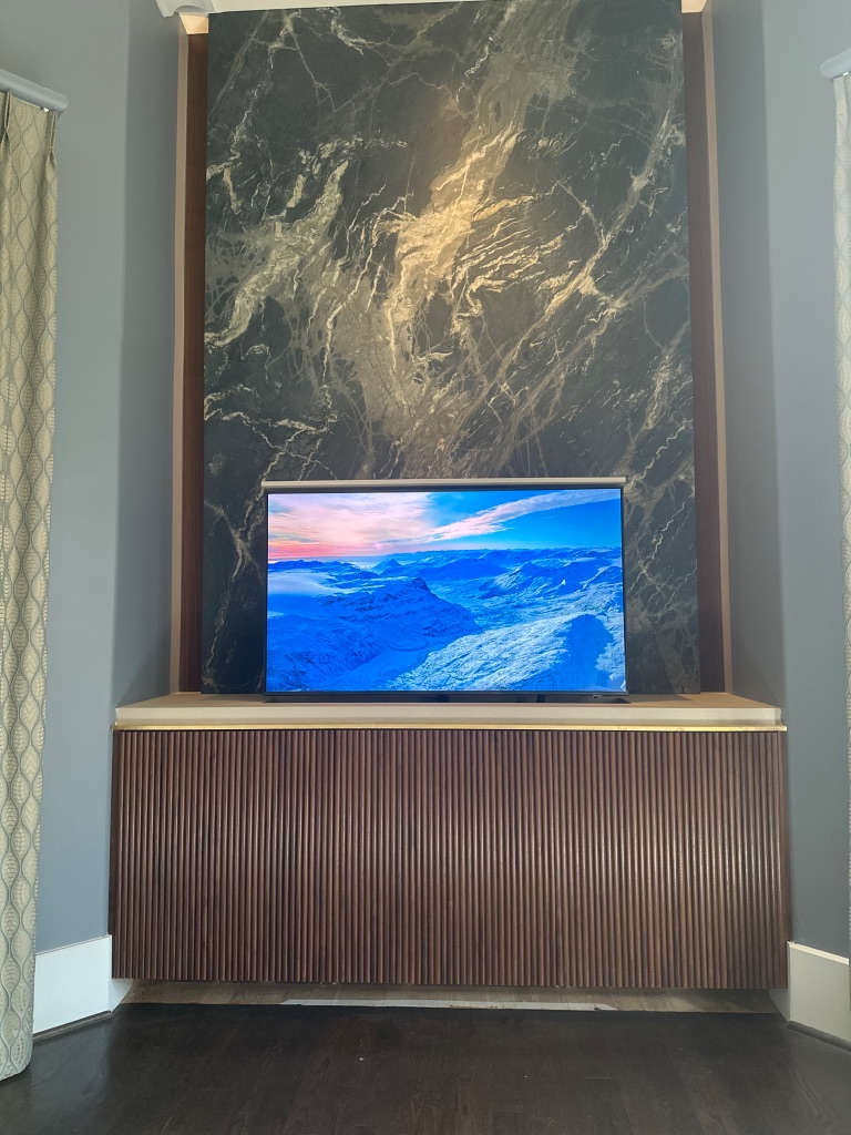 DLSAV motorized TV lift rising from custom marble console