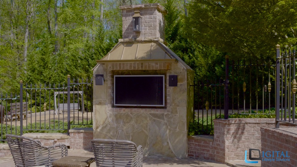 DLSAV outdoor TV integrated into stone fireplace structure